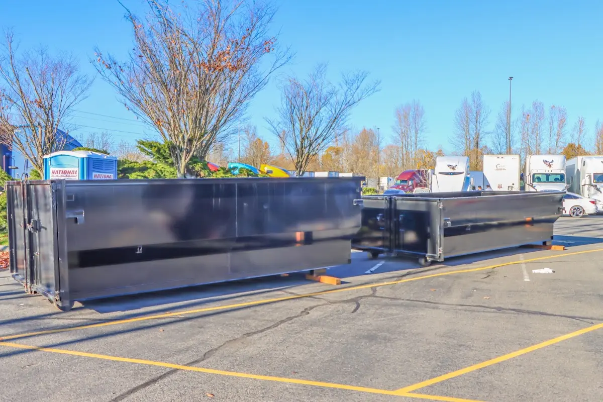 Professional dumpster rental service with roll-off container on residential driveway in Moore